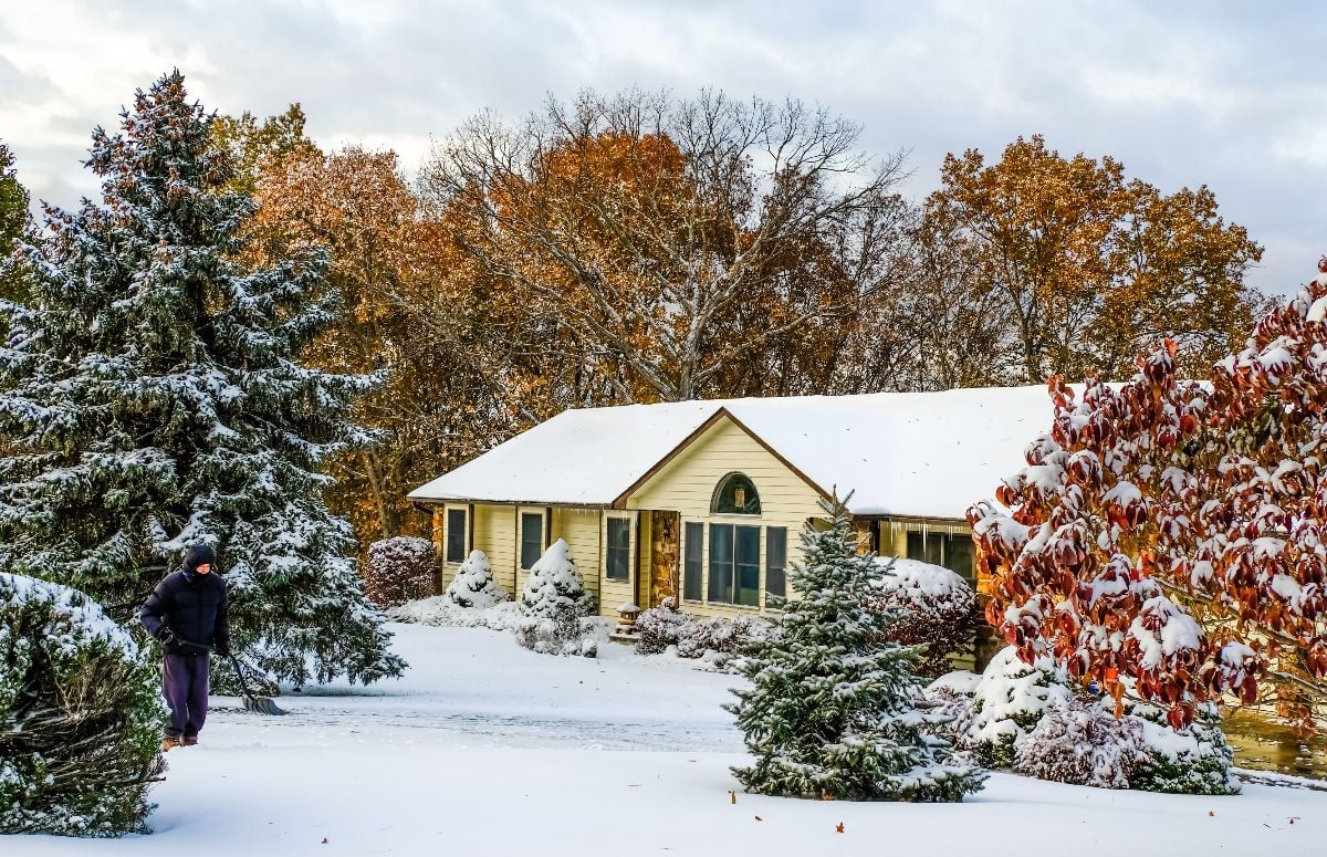 Midwestern house and landscape covered with early snow.