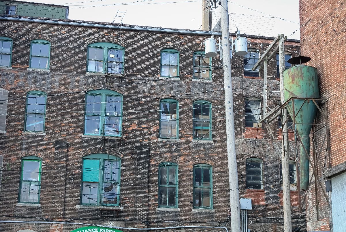 An old factory building with faded lettering and green details in the West Bottoms district.