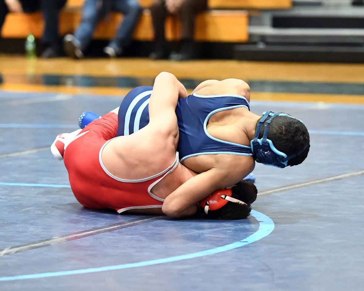 Athletic male wrestlers competing at a wrestling meet.