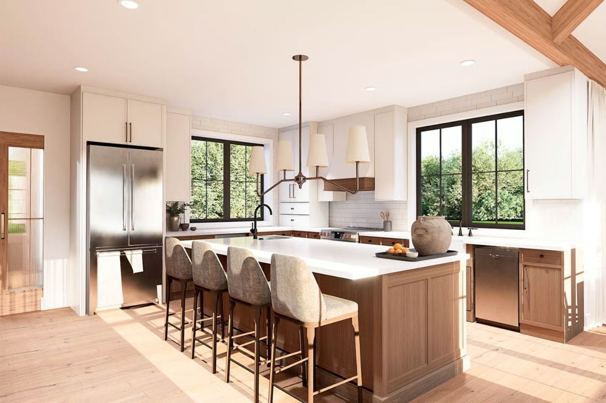 Painted White Cabinetry Balances Natural Wood Tones Across the Island and Beams