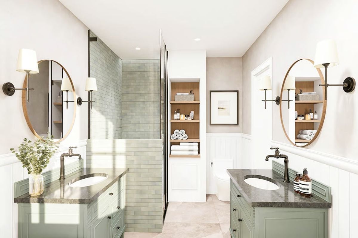 Oval Mirrors With Wood Frames Echo Each Other Across a Symmetrical Double Vanity