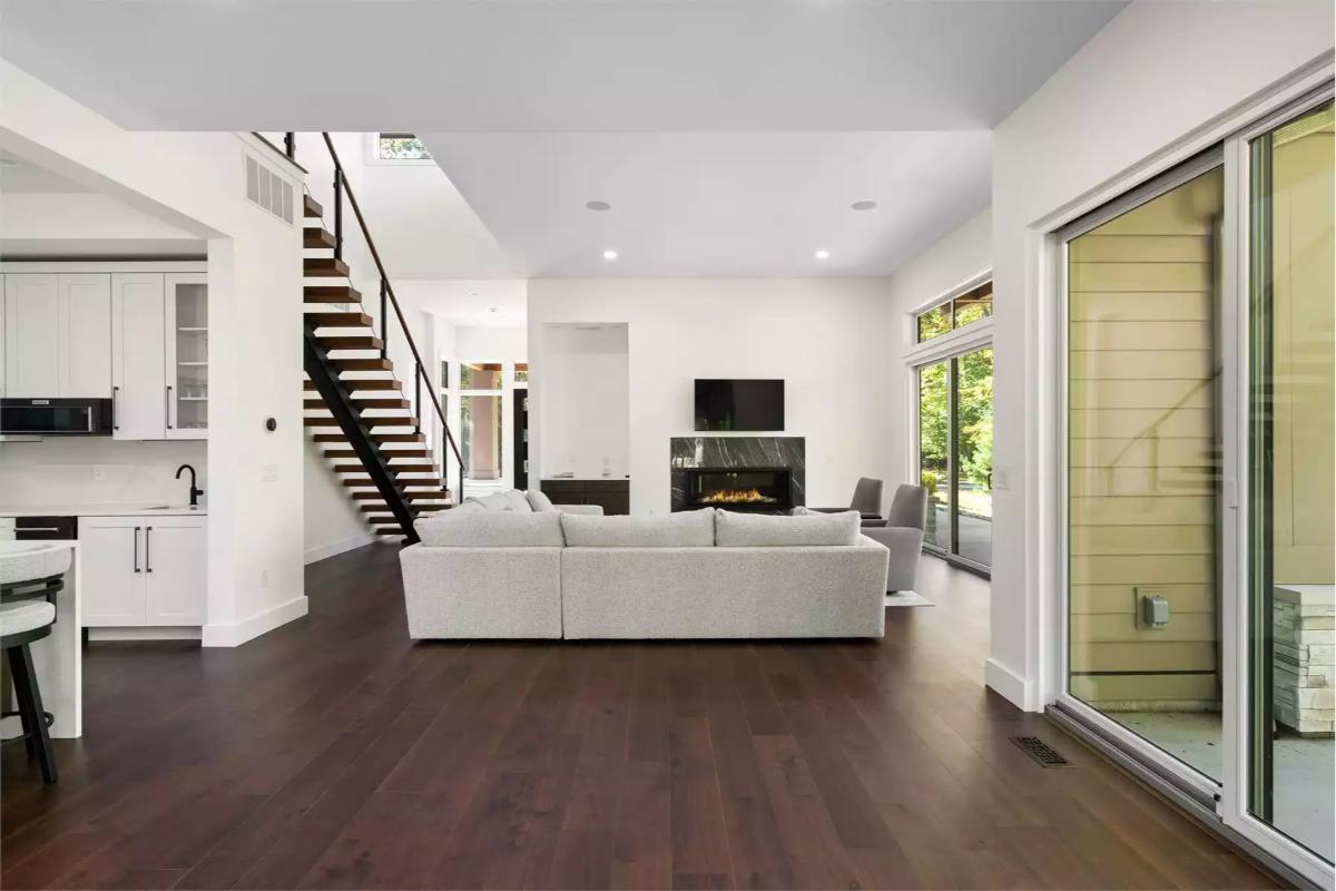 Open-Concept Living Space with Floating Staircase and Fireplace