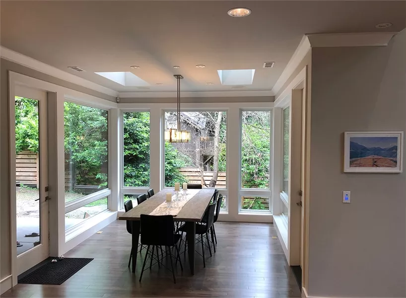 Dining Room with Floor-to-Ceiling Windows and Skylight Tray Ceiling