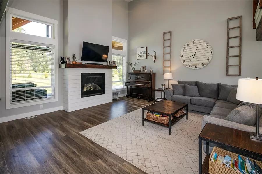 Farmhouse Living Room with Shiplap Fireplace and Vaulted Ceilings