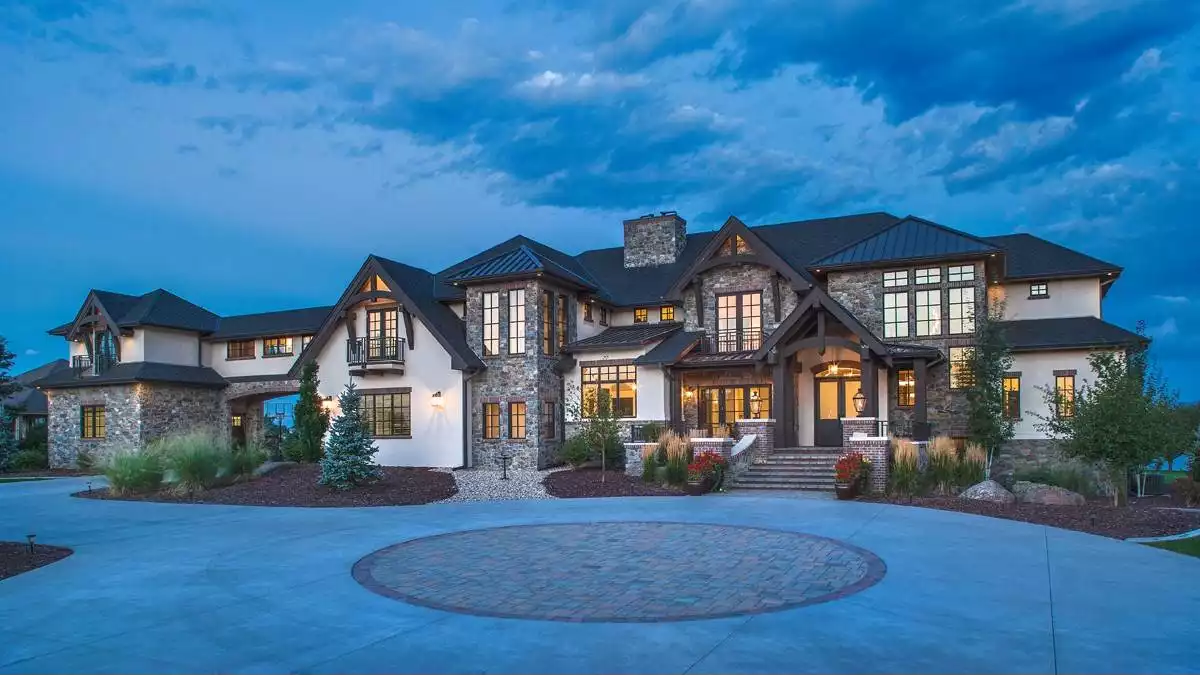 European-Style Luxury Estate Showcasing Stone and Stucco at Twilight