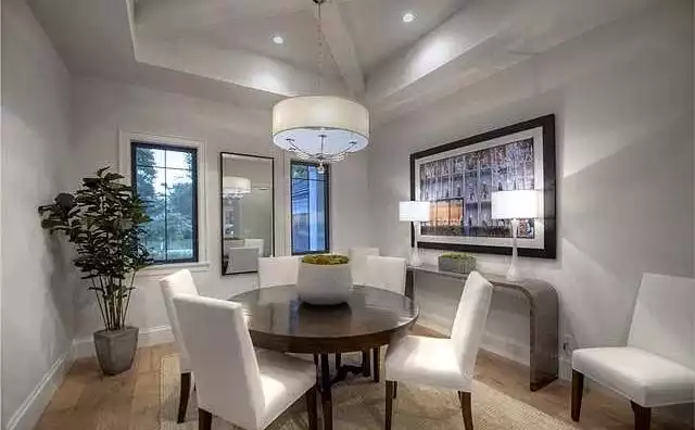 Formal Dining Room with Round Dark Wood Table and Upholstered Chairs
