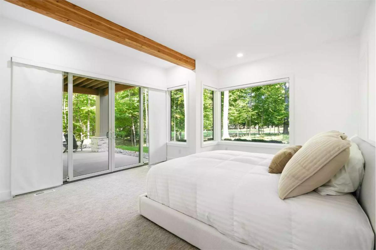 Minimalist Bedroom with Exposed Beam and Floor-to-Ceiling Glass Walls