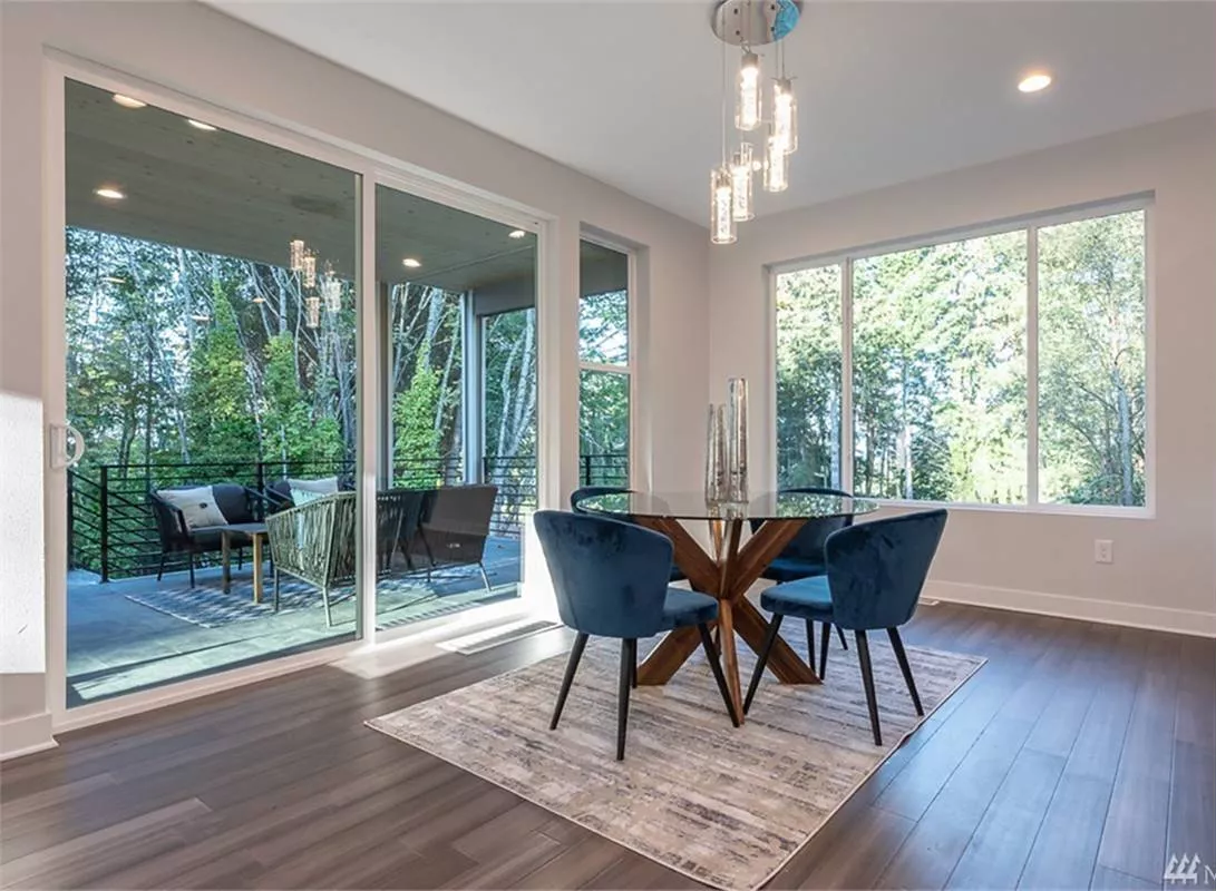 Glass Doors Slide Open to Merge the Dining Room With the Deck Outside