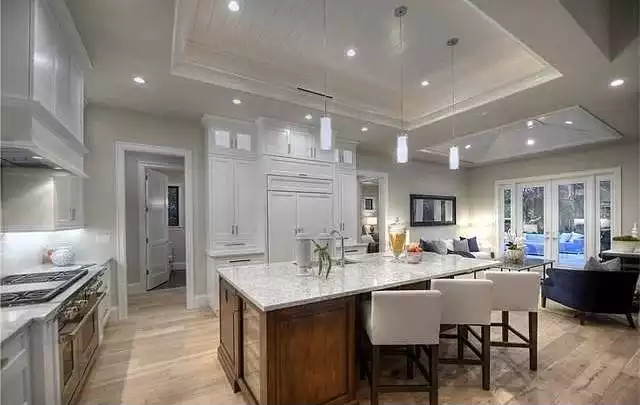Open-Concept Kitchen with White Cabinetry and Walnut Island