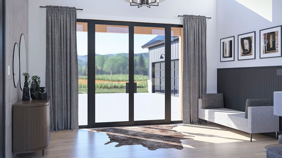 Bright Living Area with Black-Framed Glass Doors Opening to Countryside