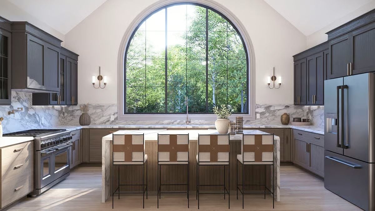 An Arched Window and Marble Backsplash Anchor This Vaulted Kitchen