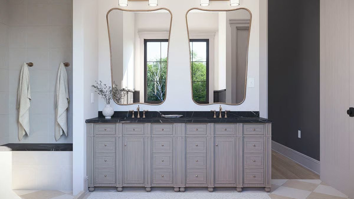 Twin Mirrors With Brass Frames Float Above a Double Vanity Built for Two