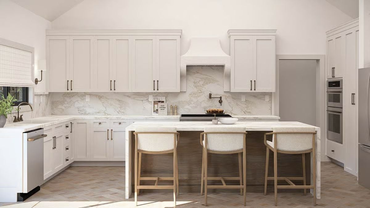 Off-White Shaker Cabinets and Waterfall Counters Define a Kitchen That Doesn't Shout