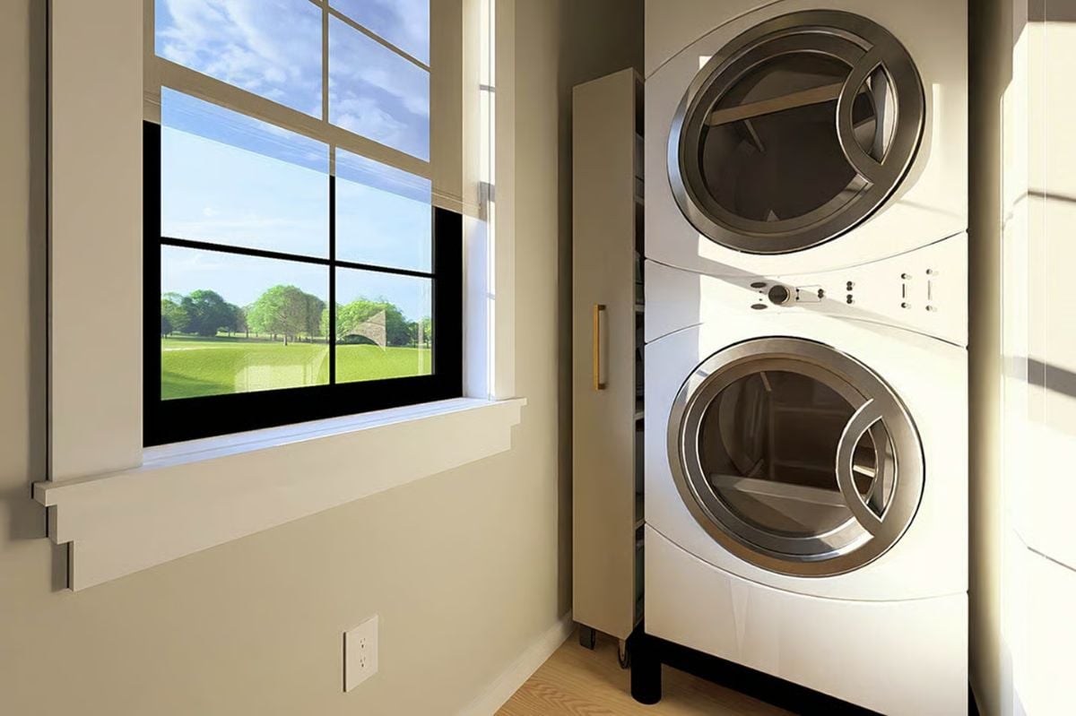 Stacked Washer and Dryer in Sunlit Laundry Alcove with Park Views