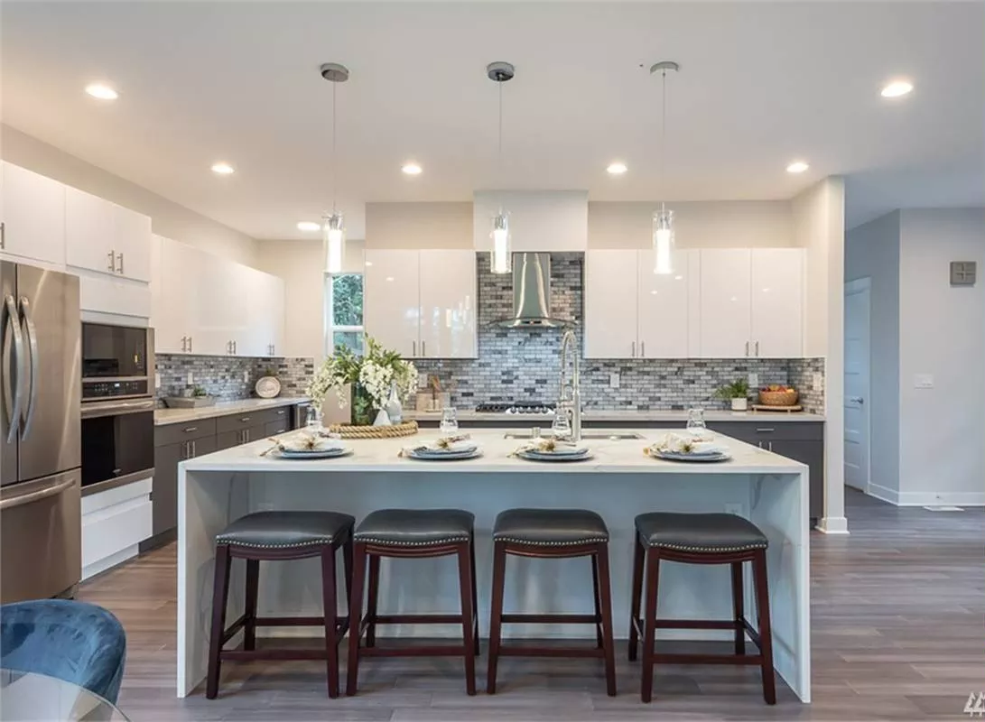 Pendant Lights Drop Over the Island So Every Seat Gets Its Own Glow