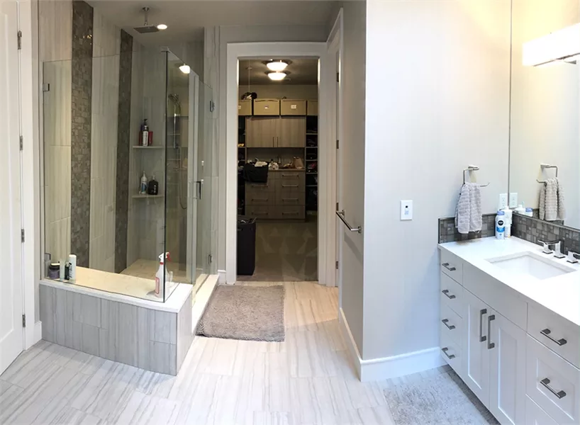 Spa-Inspired Master Bath with Glass-Enclosed Shower and Walk-In Closet