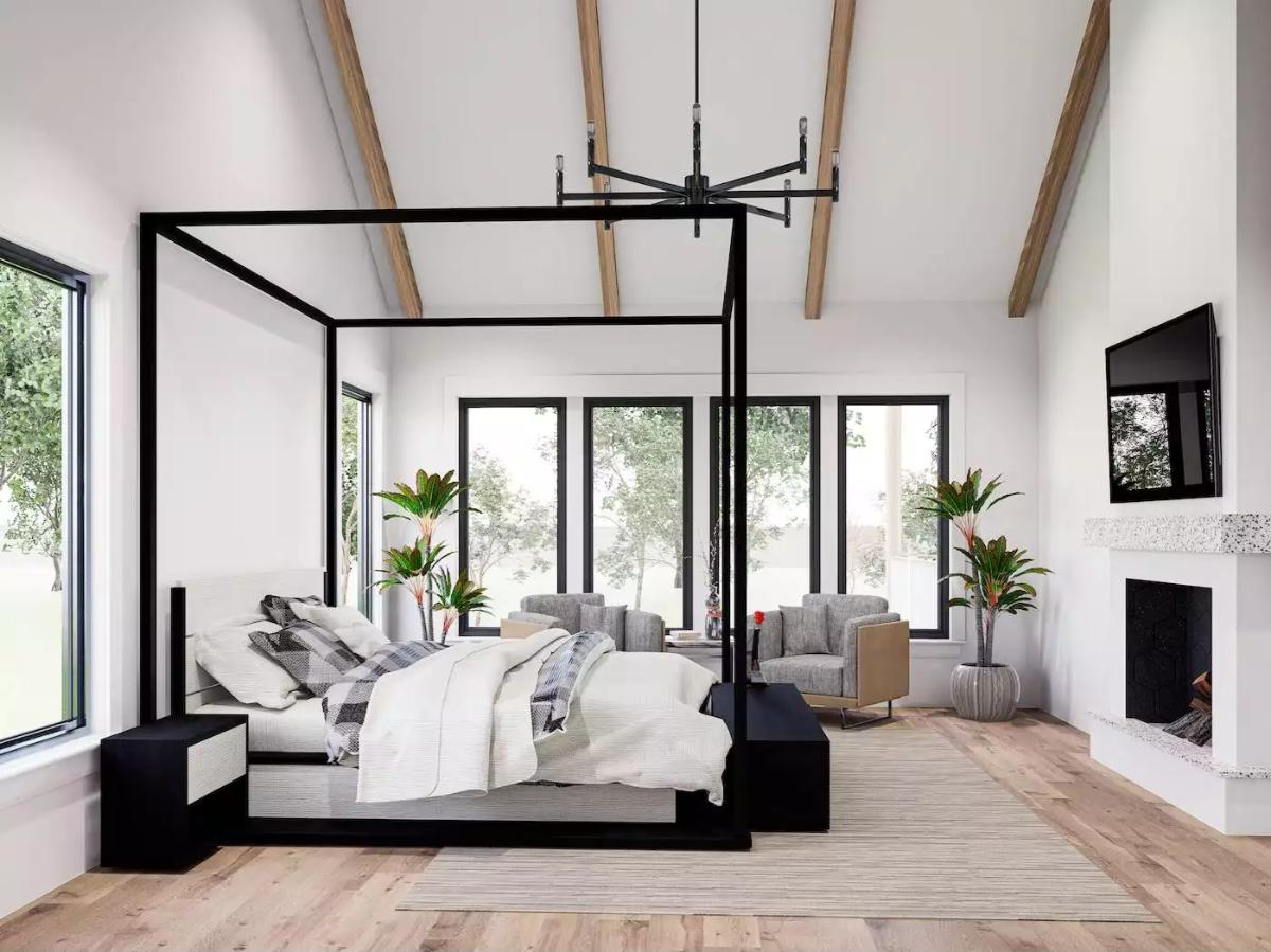 Primary Bedroom with Black Canopy Bed and Exposed Wooden Ceiling Beams