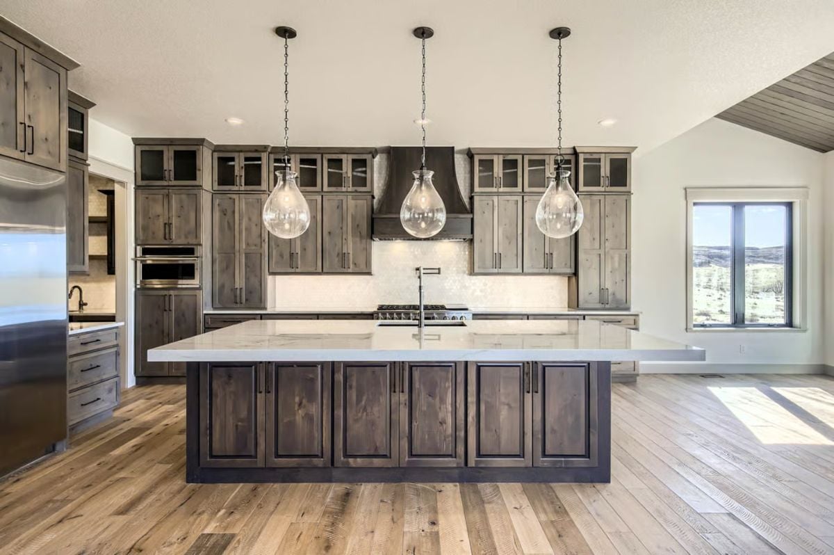 Rustic Kitchen with Weathered Gray Cabinetry and Marble Waterfall Island