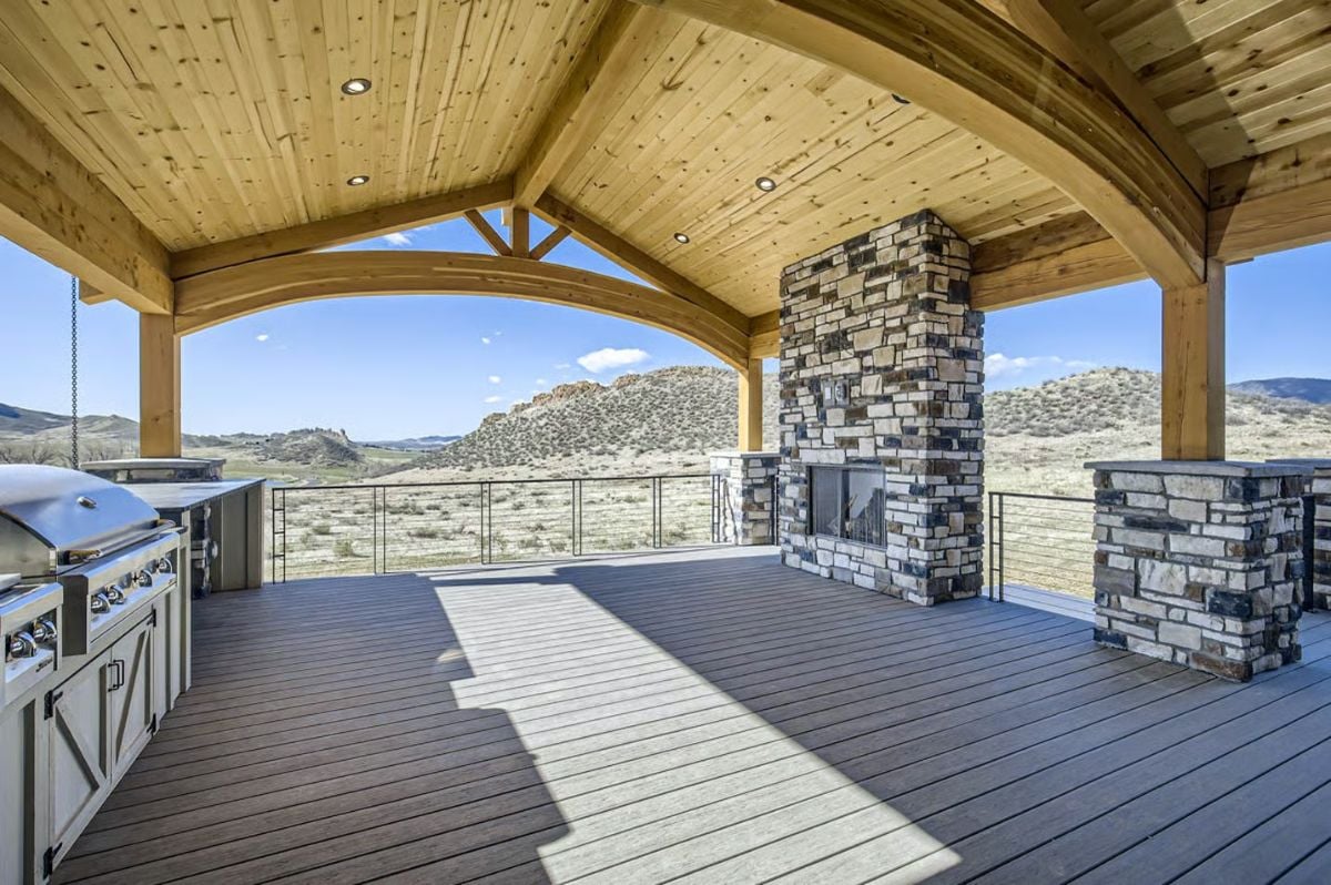 Covered Deck with Stone Fireplace and Built-In Grill Overlooking Desert