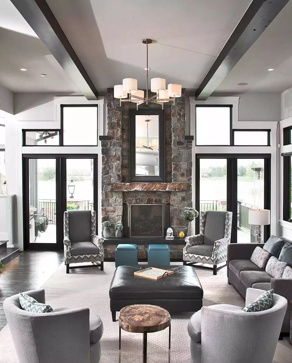 Vaulted Living Room with Stone Fireplace and Chevron-Patterned Accent Chairs