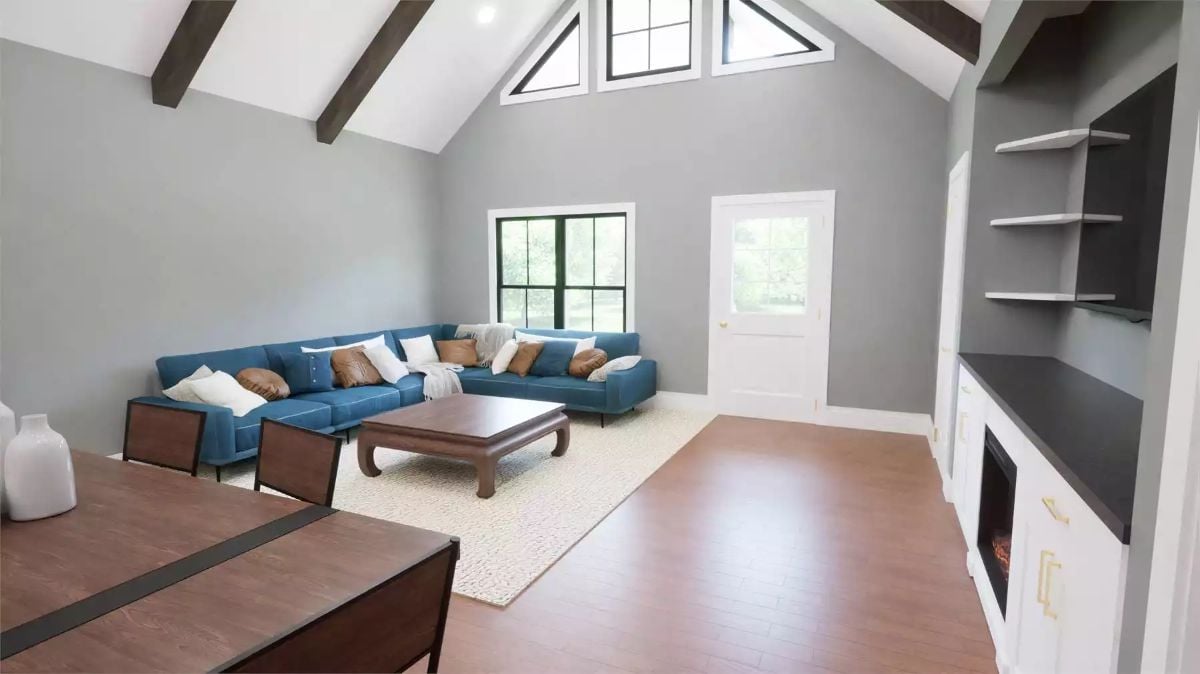 Vaulted Living Room with Exposed Beams and Blue Sectional Seating