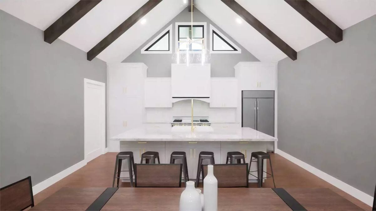 Vaulted Kitchen and Dining Area with Dark Wood Beams and Metal Stools