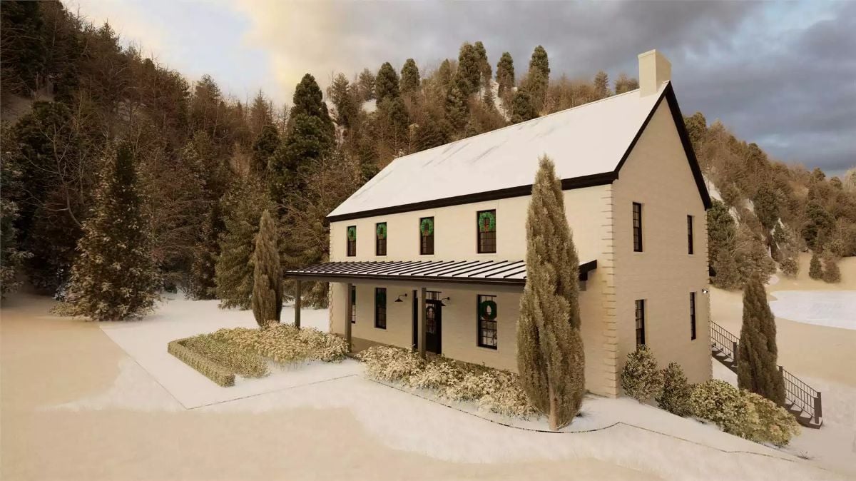 Snow-Dusted Modern Farmhouse Nestled Against Forested Hillside