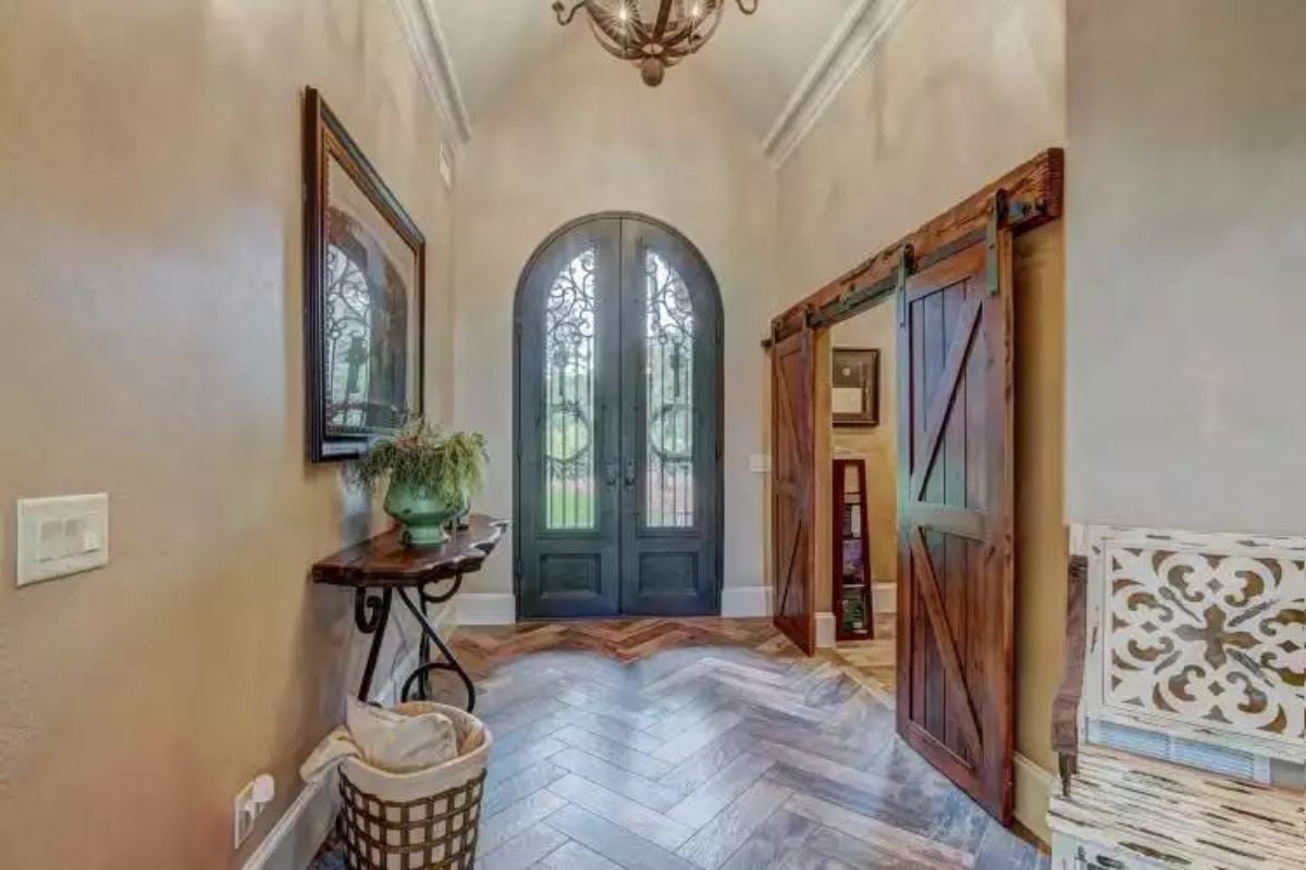 Arched Double Doors with Decorative Ironwork Welcome Guests Inside