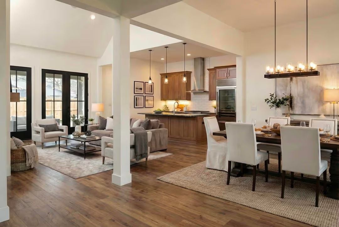 Warm Wood Tones and White Columns Anchor an Open-Concept Farmhouse Interior