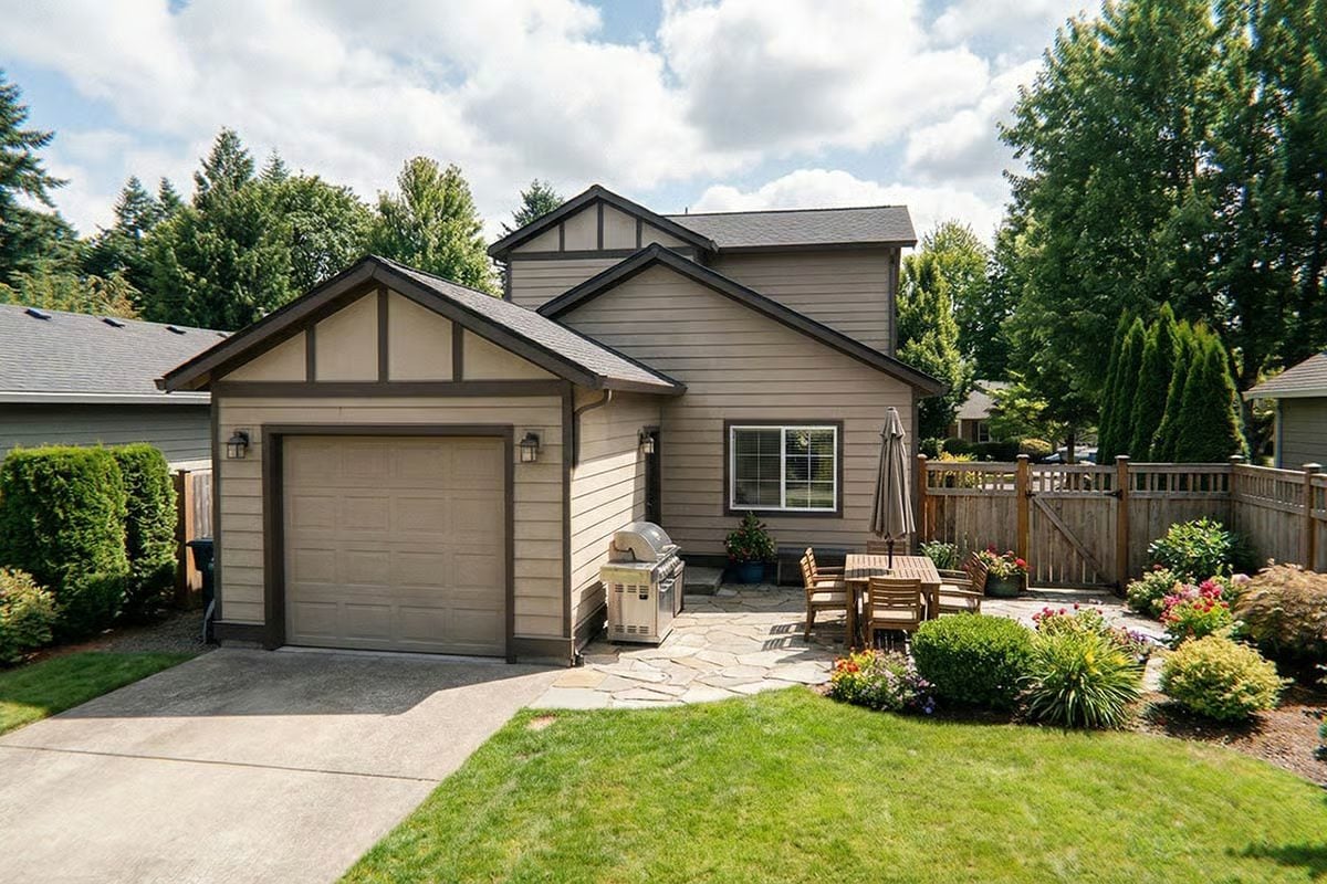 Exterior View with Landscaped Front Yard and Patio Seating