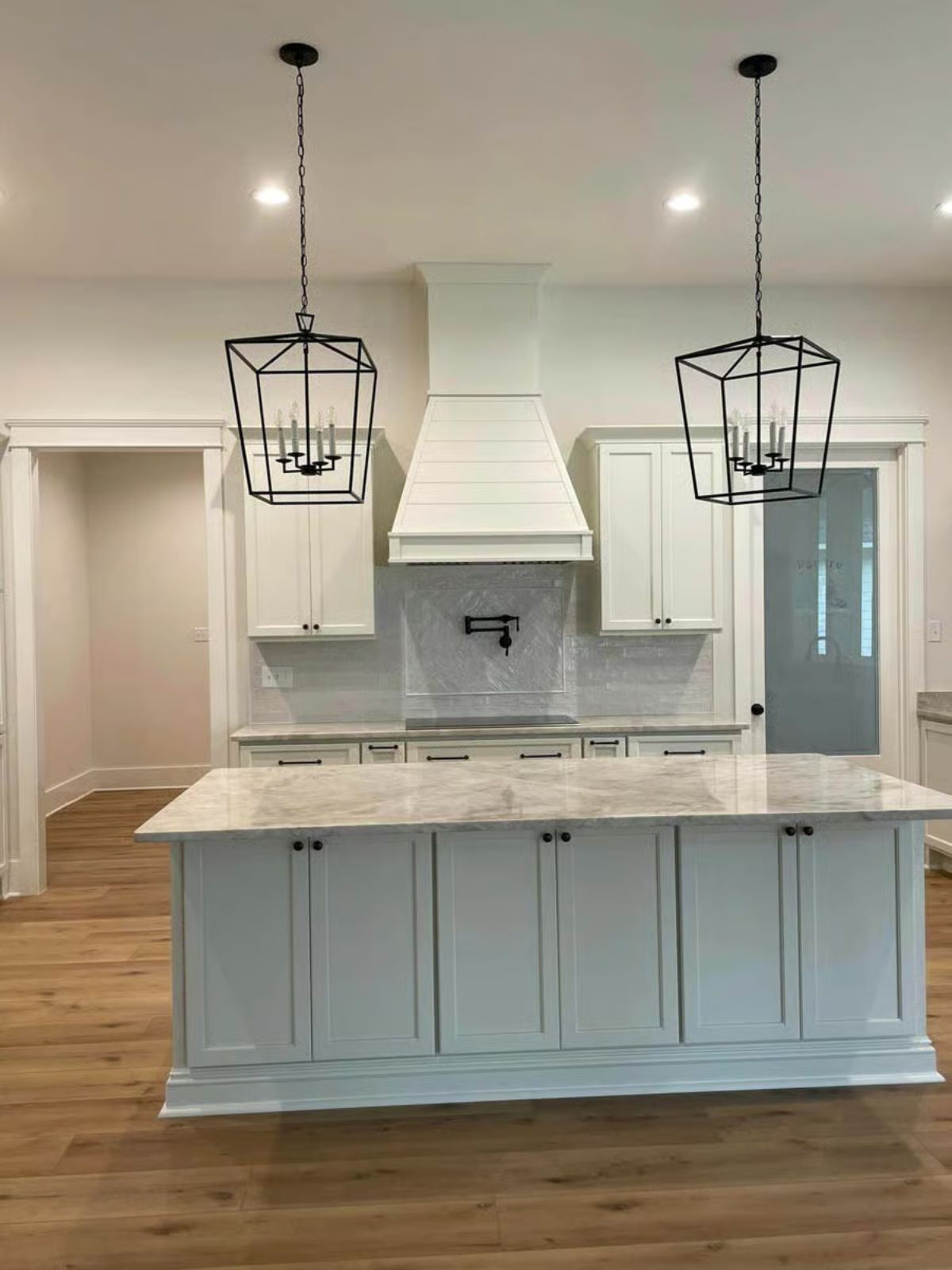 Kitchen Island with Lantern Pendants and Marble Countertops