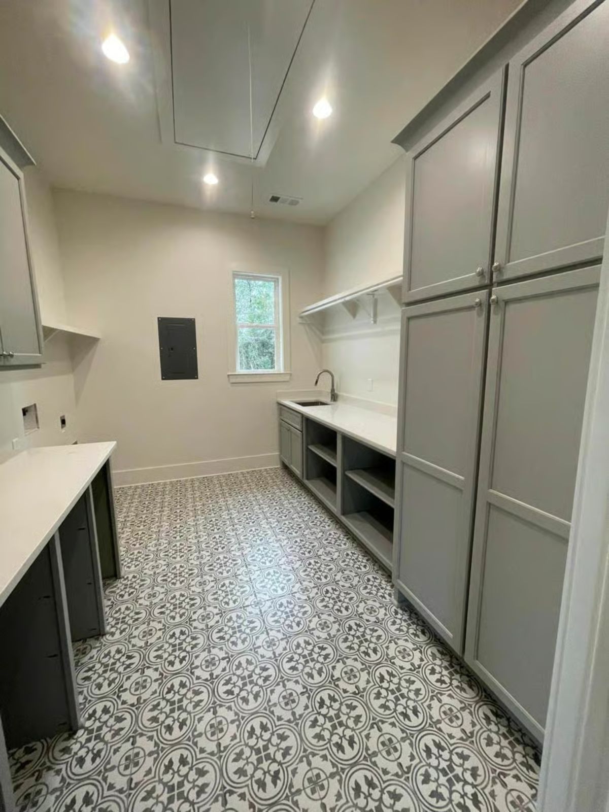 Laundry Room with Patterned Tile Flooring and Gray Shaker Cabinets