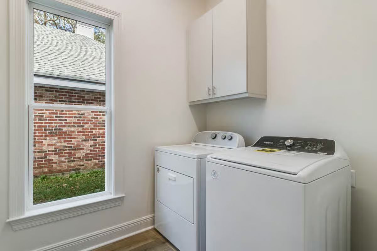 Laundry Room with White Top-Load Washer and Dryer Set