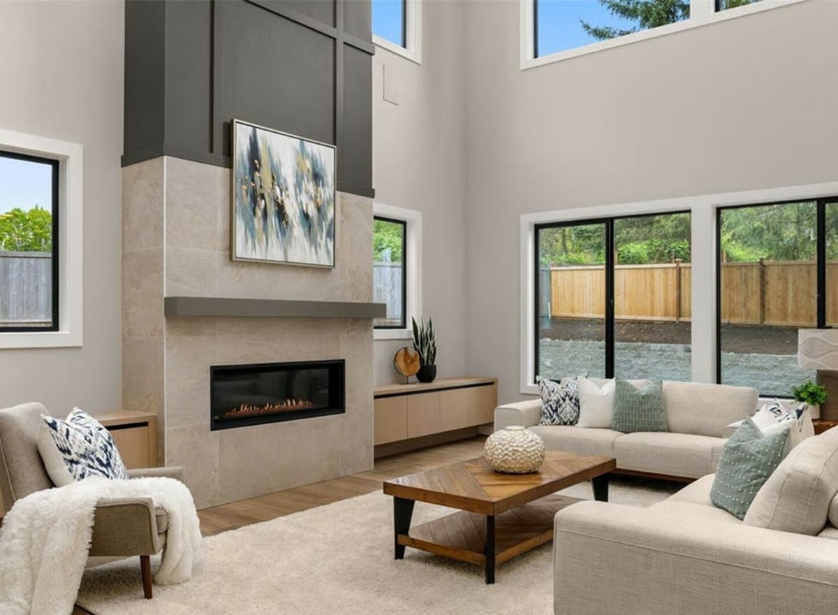 Tile, Wood, and a Linear Fireplace Define a Double-Height Living Room