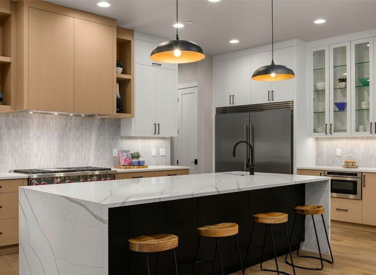 Marble Island, Black Base, and Wood Stools Pull a Kitchen in Three Directions