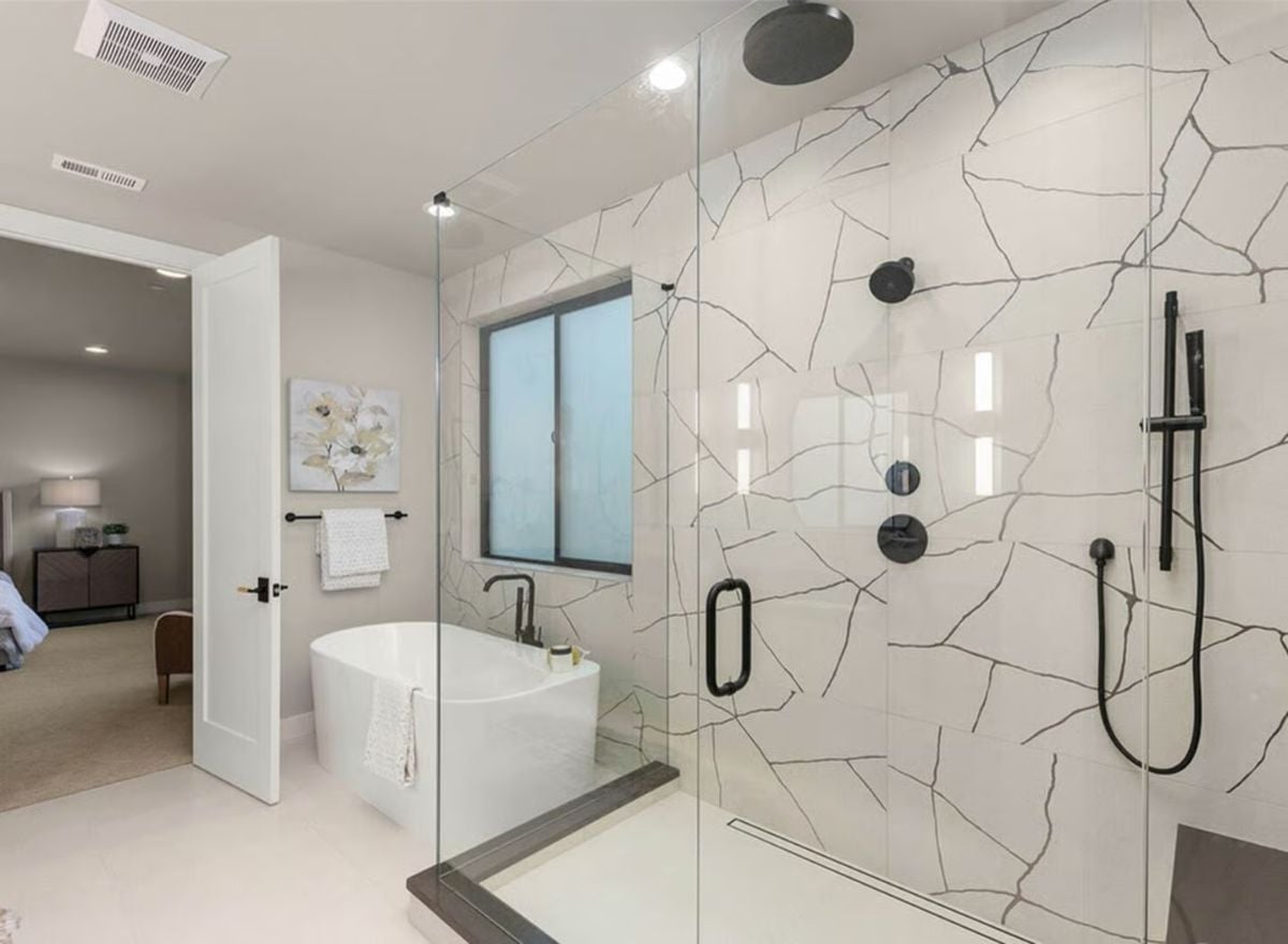 Cracked-Marble Tile and Glass Enclose a Shower Built for Two