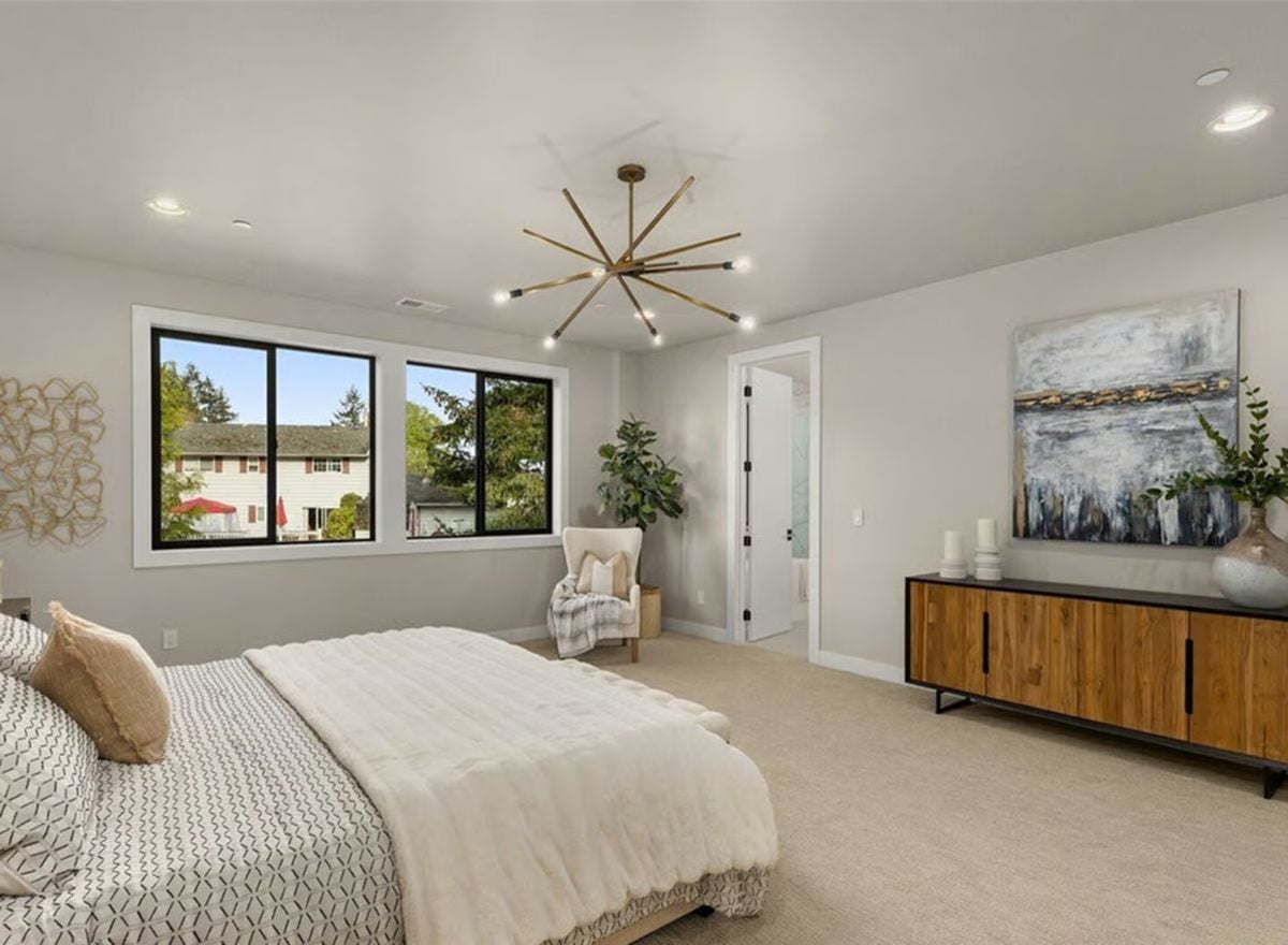 Gold Sputnik Light and Carpet Flooring Ground a Primary Suite Built for Quiet