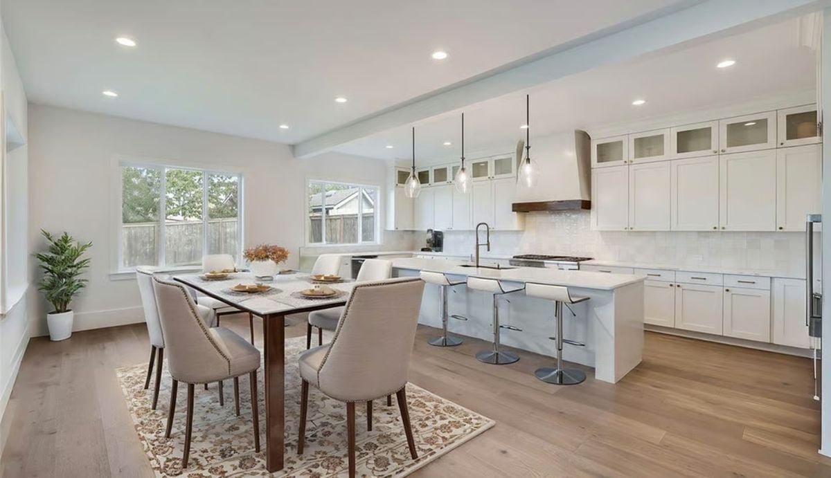 Pendant Lights and a Wood-Topped Range Hood Anchor This Open Kitchen