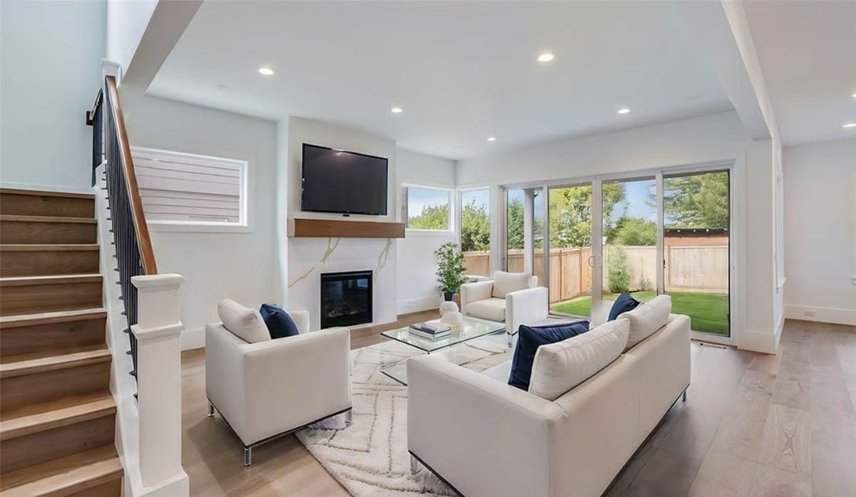 Navy Accents and a Marble Fireplace Surround Ground This Open Living Room