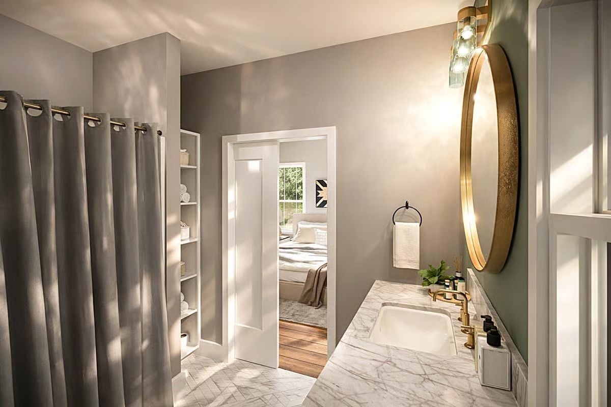 Sophisticated Bathroom with Marble Vanity and Gold-Rimmed Mirror