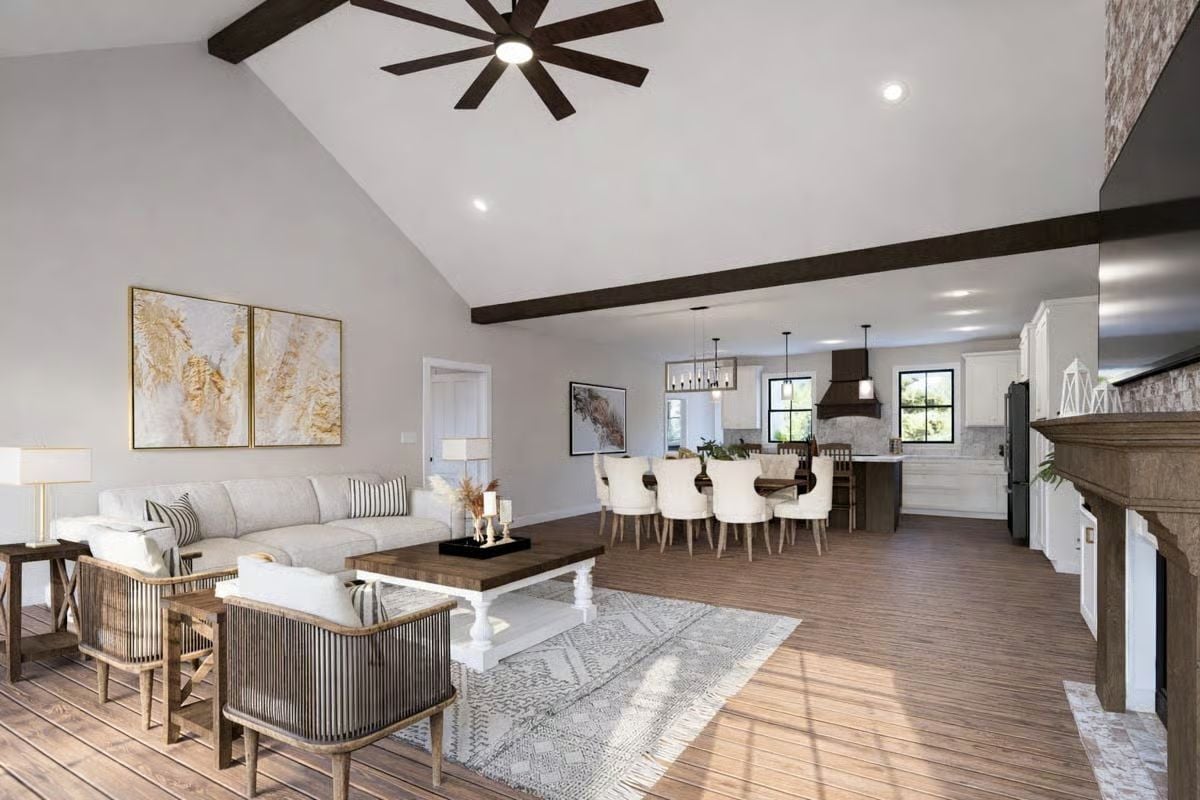 Vaulted Ceilings and Dark Wood Beams Define This Open-Plan Living Space
