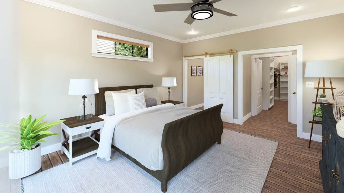 Dark Wood Sleigh Bed and Barn Door Hardware Give This Primary Bedroom Character