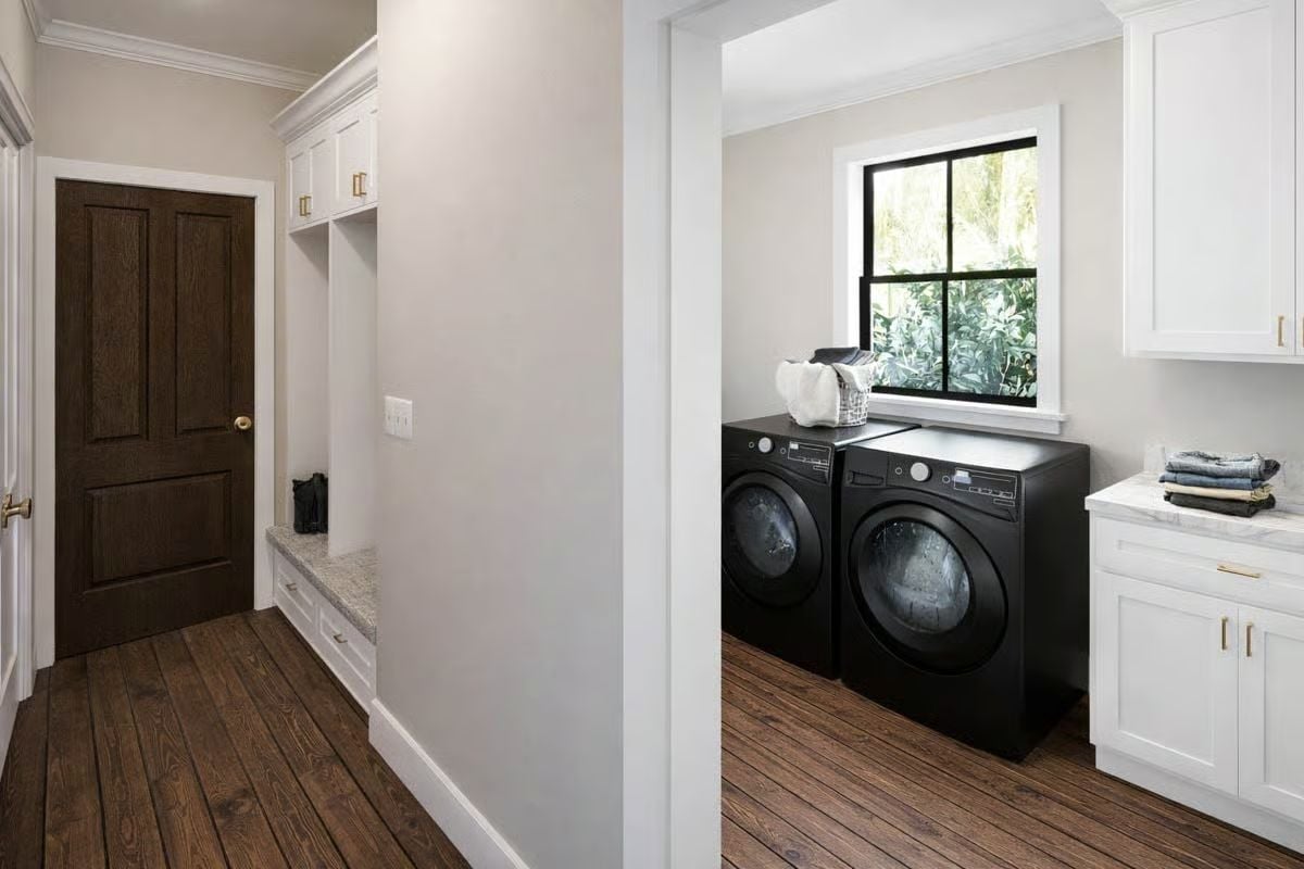 Black Front-Load Machines and Hardwood Floors Make This Laundry Room Work Hard