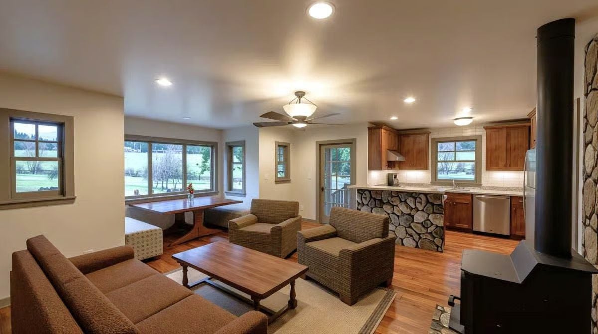 Stone-Clad Kitchen Bar, Wood Stove, and Hardwood Floors in One Space