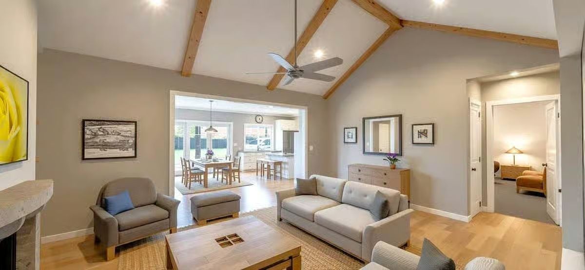 Vaulted Living Room with Exposed Wood Beams and Neutral Gray Palette