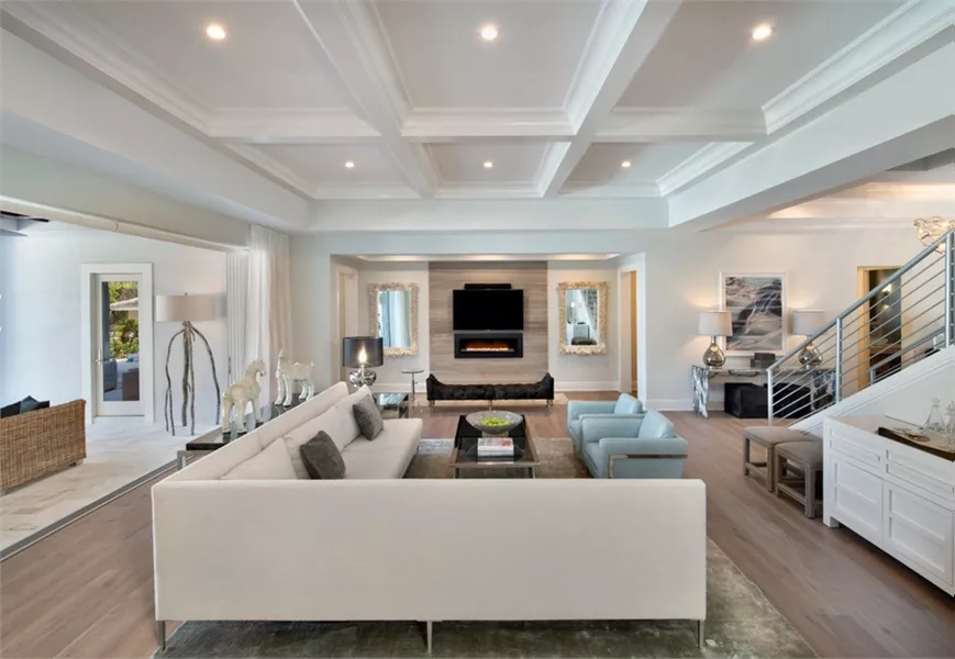 Coffered Ceilings and a Linear Fireplace Anchor This Open Living Space
