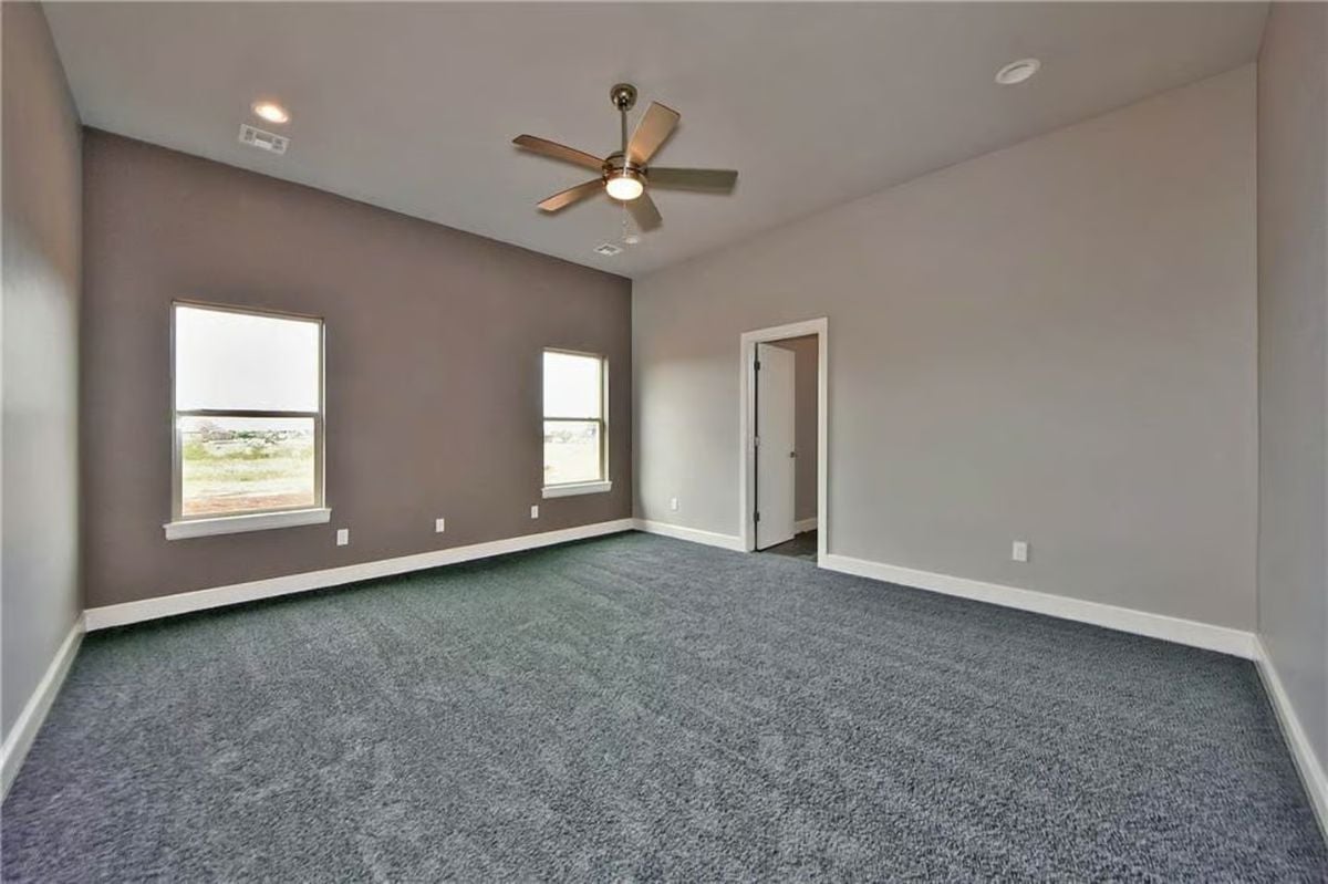 Dark Carpet and Vaulted Walls Give This Bedroom Unexpected Depth
