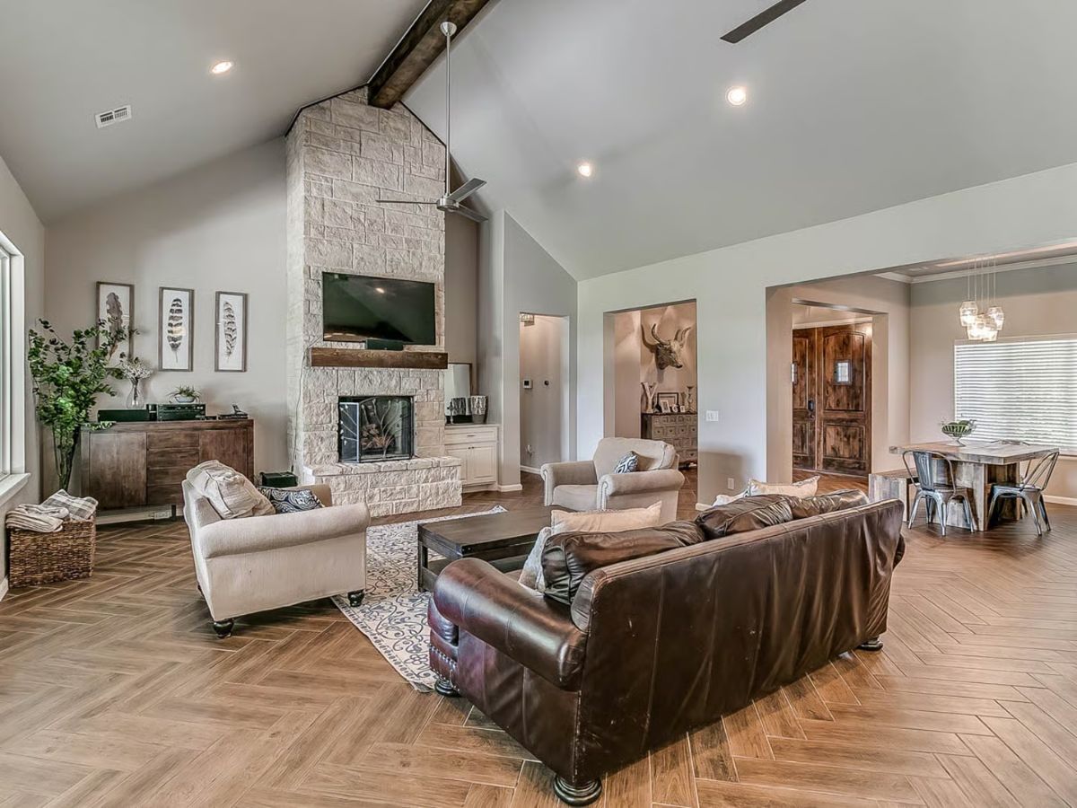 Open-Concept Living Room with Vaulted Ceiling and Stone Fireplace