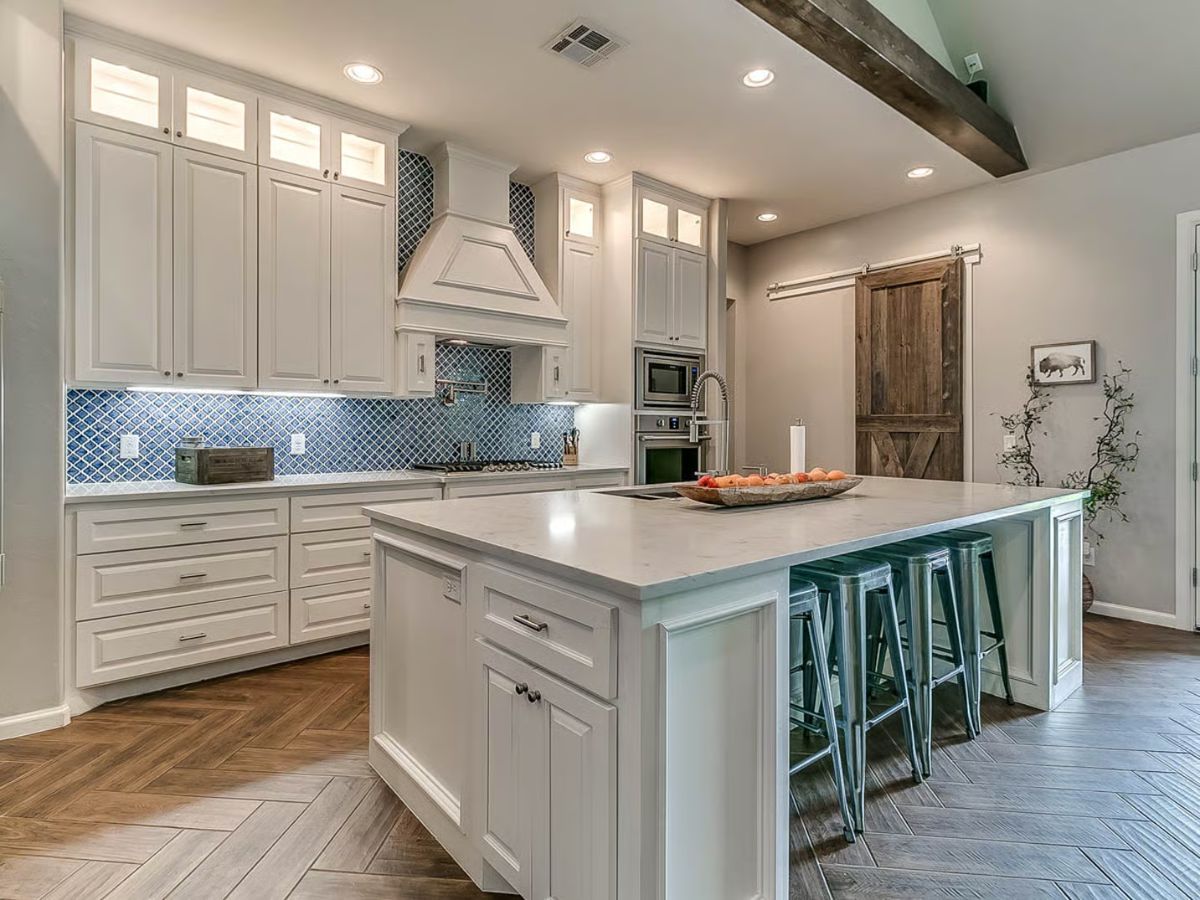 Kitchen with Blue Quatrefoil Backsplash and White Shaker Cabinetry