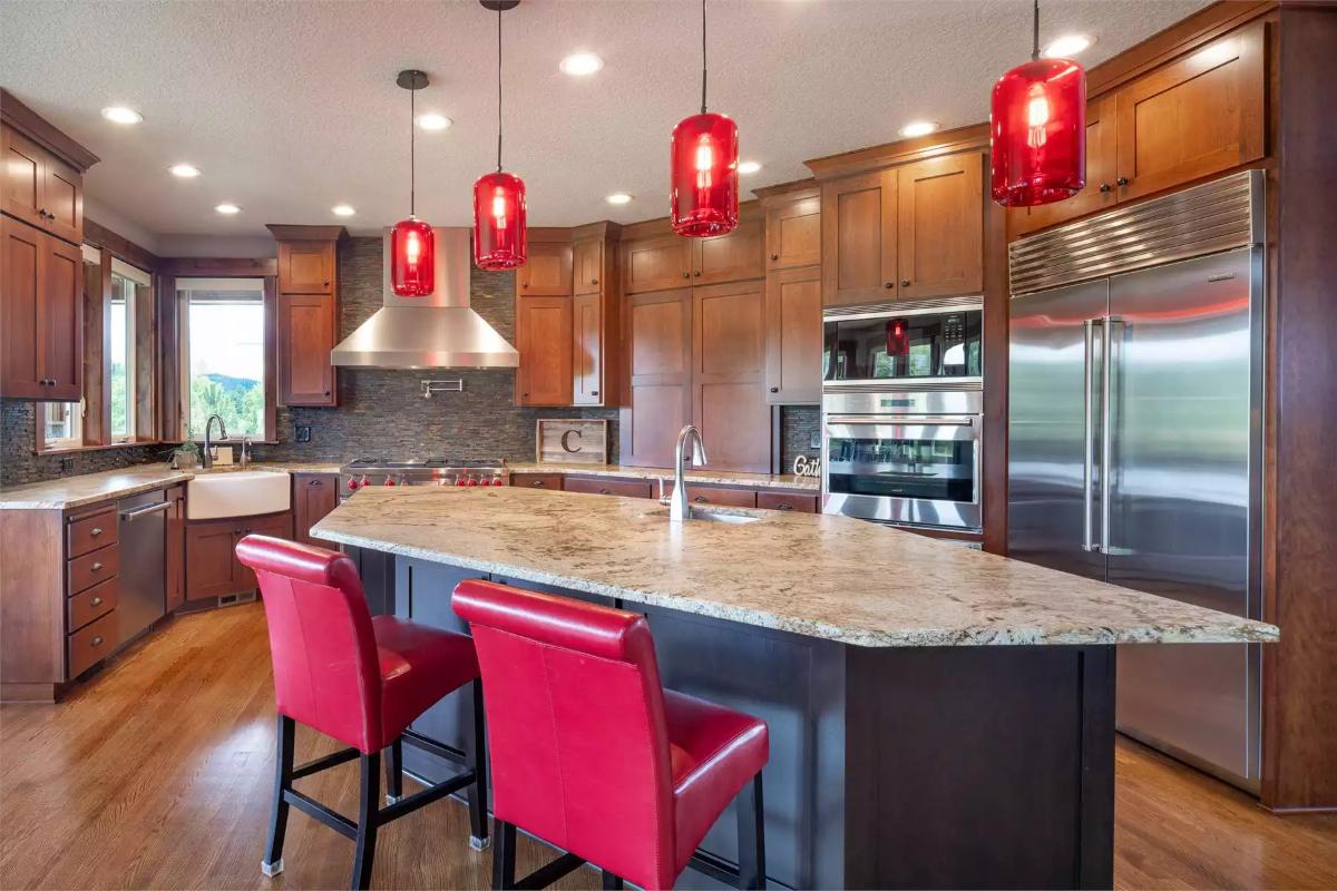 Red Glass Pendants and Granite Island Make a Bold Statement in This Craftsman Kitchen